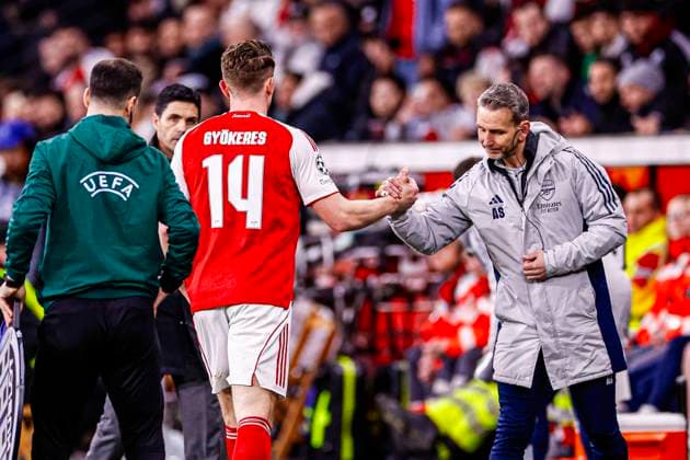 Viktor Gyokeres of Arsenal FC gives a hand to Assistant Coach Albert Stuivenberg of Arsenal FC Bayer 04 Leverkusen v Arsenal FC, UEFA Champions League 2025 26 Round of 16 First Leg, Bayer 04 Leverkusen v Arsenal FC, BayArena, March 11, 2026, Leverkusen, Germany.