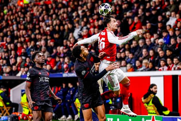 Martin Zubimendi of Arsenal FC heads the ball with Jarell Quansah of Bayer 04 Leverkusen Bayer 04 Leverkusen v Arsenal FC, UEFA Champions League 2025 26 Round of 16 First Leg, Bayer 04 Leverkusen v Arsenal FC, BayArena, March 11, 2026, Leverkusen, Germany.