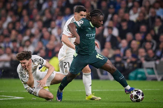 Real Madrid CF s Thiago Pitarch (l) and Manchester City FC s Jeremy Doku during Champions League 2025 2026 match. March 11,2026. (20260311007)