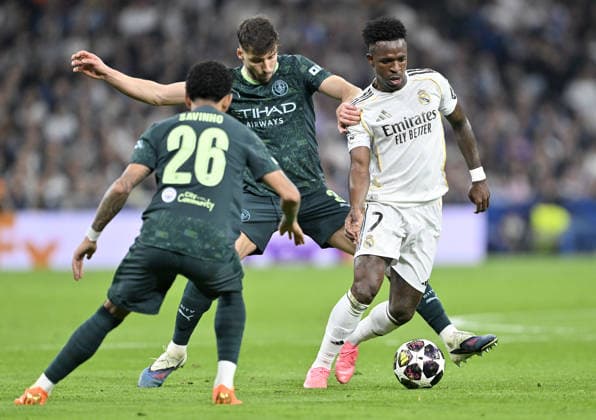 Real Madrid v Manchester City - UEFA Champions League MADRID, SPAIN - MARCH 11: Vinicius Junior (R) of Real Madrid in action against Ruben Dias (C) of Manchester City during the UEFA Champions League round of 16 match between Real Madrid and Manchester City at the Bernabeu Stadium in Madrid, Spain, on March 11, 2026. Burak Akbulut Anadolu Madrid Spain. Editorial use only. Please get in touch for any other usage.  Copyright: x2026xAnadoluxBurakxAkbulutx