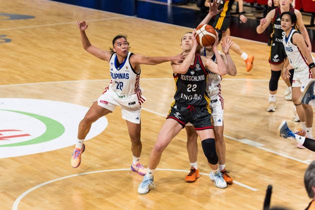 LYON-VILLEURBANNE, FRANCE - MARCH 12: Emily Bessoir (Germany, 22) controls the ball, fouled by Kacey Dela Rosa (Philippines, 28) during the FIBA Women™s World Cup Qualifying Tournament match between Philippines (PHI) vs. Germany (GER) at Astroballe on matchday 2 of the FIBA Women™s World Cup Qualifying Tournament on March 12, 2026 in Lyon-Villeurbanne, France. France Copyright: xSteffiexWunderlx