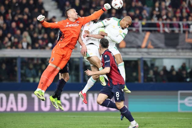 Lukasz Skorupski of Bologna FC and Donyell Malen of AS Roma compete for the ball during the UEFA Europa League 2025 2026 football match between Bologna FC and AS Roma at Renato dall Ara stadium in Bologna (Italy), March 12th, 2026. cesarexpurini