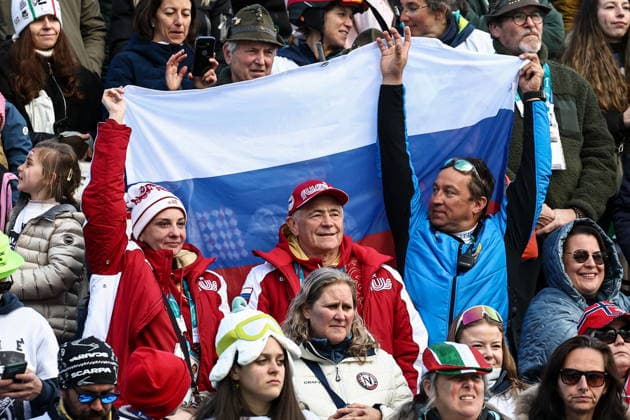ITALY, VENETO - MARCH 13, 2026: Fans with a Russian flag are seen during the victory ceremony for the men s para alpine skiing giant slalom standing event at Tofane Alpine Skiing Centre during the 2026 Winter Paralympic Games, in Cortina d Ampezzo, Province of Belluno 2026 Winter Paralympics: Para Alpine Skiing  - ZUMAt113 20260313_zaa_t113_296 Copyright: xMikhailxTereshchenkox