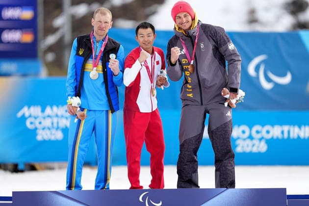 (260314) -- TESERO, March 14, 2026 -- Gold medalist Jiayun Cai (C) of China poses with silver medalist Grygorii Vovchynskyi (L) of Ukraine and bronze medalist Marco Maier of Germany after the para biathlon men s sprint pursuit standing at the Milan-Cortina 2026 Paralympic Winter games, Winterspiele,Spiele, Summer games in Tesero, Italy, March 13, 2026. ) (SP)ITALY-TESERO-PARALYMPIC WINTER GAMES-PARA BIATHLON-MEN S SPRINT PURSUIT STANDING HouxZhaokang 