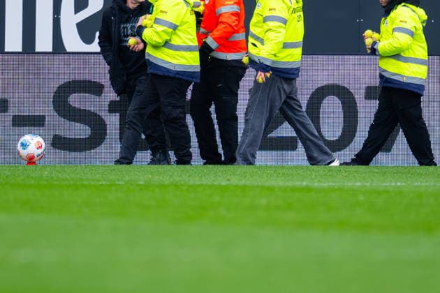 14 03 2026 Football, 2025 2026, 2 Bundesliga, Matchday 26, DSC Arminia Bielefeld SC Paderborn 07 Stewards with tennis balls thrown onto the pitch by Paderborn fans DFL REGULATES PROHIBIT ANY USE OF PHOTOGRAPHS AS IMAGE SEQUENCES AND OR QUASI VIDEO