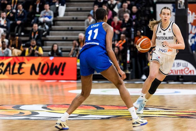LYON-VILLEURBANNE, FRANCE - MARCH 14: Emily Bessoir (Germany, 22) controls the ball against Valeriane Ayayi (France, 11) during the FIBA Women™s World Cup Qualifying Tournament match between Germany (GER) vs. France (FRA) at Astroballe on matchday 3 of the FIBA Women™s World Cup Qualifying Tournament on March 14, 2026 in Lyon-Villeurbanne, France. France Copyright: xSteffiexWunderlx