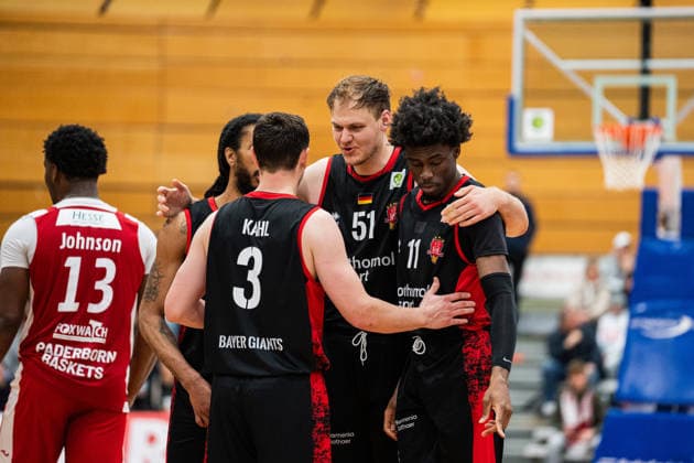 Paderborn Baskets GER vs Bayer Giants Leverkusen GER , Basketball, Barmer 2 Basketball Bundesliga Pro A, 27 Matchday, 14 3 2026, Season 2025 2026, Paderborn v l Kobe Langley Bayer Giants Leverkusen, 08 , Luca Finn Kahl Bayer Giants Leverkusen, 03 , Soeren Urbansky Bayer Giants Leverkusen, 51 and Ricardo Lynch Bayer Giants Leverkusen, 11 stand together in front of a free throw Paderborn Sports Center Maspernplatz Germany