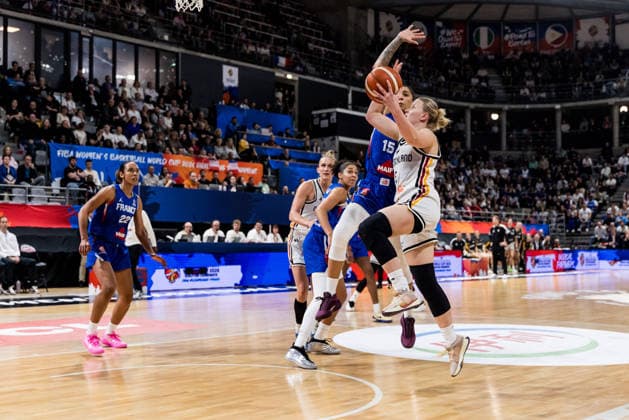 LYON-VILLEURBANNE, FRANCE - MARCH 14: Emma Eichmeyer (Germany, 9) shoots the ball against Gabby Williams (France, 15) trying to defend during the FIBA Women™s World Cup Qualifying Tournament match between Germany (GER) vs. France (FRA) at Astroballe on matchday 3 of the FIBA Women™s World Cup Qualifying Tournament on March 14, 2026 in Lyon-Villeurbanne, France. France Copyright: xSteffiexWunderlx