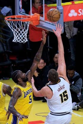 March 14, 2026, Los Angeles, California, USA: Nikola Jokic 15 of the Denver Nuggets makes a two point shot as Deandre Ayton 5 of the Los Angeles Lakers defends the basket during their regular season NBA, Basketball Herren, USA game on Saturday March 14, 2026 at Crypto.com Arena in Los Angeles, California. Lakers defeat Nuggets, 127-125. ARIANA RUIZ PI Los Angeles USA - ZUMAp124 20260314_zaa_p124_037 Copyright: xArianaxRuizx