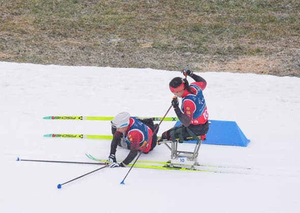 (260315) -- TESERO, March 15, 2026 -- Zhai Yuxin (L) of China falls down during the para cross-country skiing women s 20km interval start sitting at the Milan-Cortina 2026 Paralympic Winter games, Winterspiele,Spiele, Summer games in Tesero, Italy, March 15, 2026. ) (SP)ITALY-TESERO-PARALYMPIC WINTER GAMES-PARA CROSS-COUNTRY SKIING-WOMEN S 20KM INTERVAL START SITTING LianxZhen 