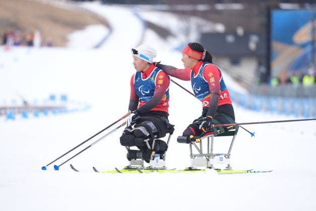 (260315) -- TESERO, March 15, 2026 -- Wang Shiyu (R) and Zhai Yuxin of China react after the para cross-country skiing women s 20km interval start sitting at the Milan-Cortina 2026 Paralympic Winter games, Winterspiele,Spiele, Summer games in Tesero, Italy, March 15, 2026. ) (SP)ITALY-TESERO-PARALYMPIC WINTER GAMES-PARA CROSS-COUNTRY SKIING-WOMEN S 20KM INTERVAL START SITTING HouxZhaokang 