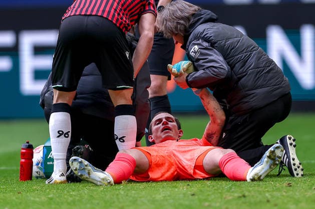 15 03 2026, Football, FC Schalke 04 Hannover 96, Matchday 26, 2 Fußball Bundesliga, Veltins Arena Gelsenkirchen, Season 2025 2026 Goalkeeper Nahuel Noll Hannover96 01 lies on the pitch in pain and needs medical attention DFB regulations prohibit any use of photographs as image sequences and or quasi video North Rhine-Westphalia Germany
