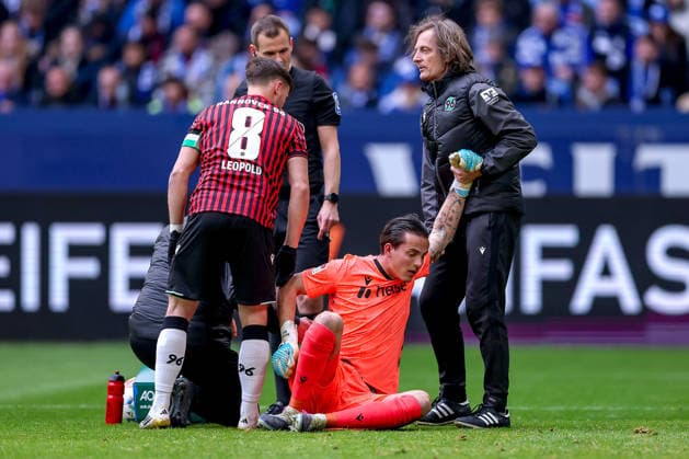 15 03 2026, Football, FC Schalke 04 Hannover 96, Matchday 26, 2 Fußball Bundesliga, Veltins Arena Gelsenkirchen, Season 2025 2026 Goalkeeper Nahuel Noll Hannover96 01 lies on the pitch in pain and needs medical attention DFB regulations prohibit any use of photographs as image sequences and or quasi video North Rhine-Westphalia Germany
