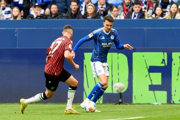 Bastian Allgeier Hannover 96 and Dejan Ljubicic FC Schalke battle for the ball during the 2 Bundesliga match between FC Schalke 04 and Hannover 96, Veltins Arena on March 15, 2026 in Gelsenkirchen, Germany, Germany Photo by Max Maiwald DeFodi Images Bastian Allgeier Hannover 96 and Dejan Ljubicic FC Schalke battle for the ball during the 2 Bundesliga match between FC Schalke 04 and Hannover 96 at Veltins Arena on March 15, 2026 in Gelsenkirchen, Germany Photo by Max Maiwald DeFodi Images Photo by Max Maiwald DeFodi Images