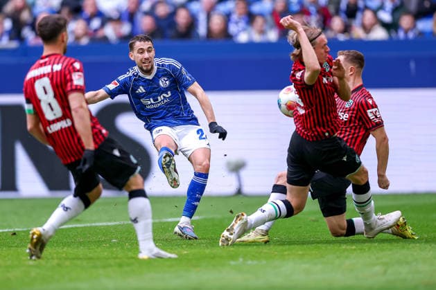 15 03 2026, Football, FC Schalke 04 Hannover 96, Matchday 26, 2 Fußball Bundesliga, Veltins Arena Gelsenkirchen, Saison 2025 2026 Adil Aouchiche Schalke04 24 in duel against Enzo Leopold Hannover96 08 Stefan Teitur Thordarson Hannover96 23 Bastian Allgeier Hannover96 17 DFB regulations prohibit any use of photographs as image sequences and or quasi video Nordrhein Westfalen Germany