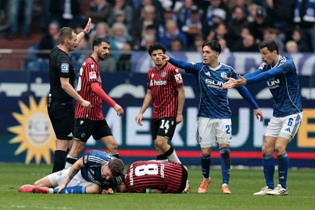 Hasan Kurucay FC Schalke 04 and Enzo Leopold Hannover 96 go to the ground after a duel during the match of the 2 Bundesliga season 2025 26 FC Schalke 04 Hannover 96 Copyright Thomas Pakusch
