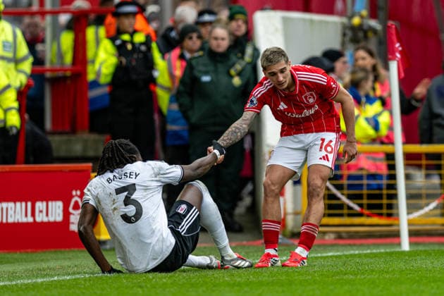15th March 2026; The City Ground, Nottingham, England; Premier League Football, Nottingham Forest versus Fulham; Nicolas Dominguez of Nottingham Forest helps Calvin Bassey of Fulham FC to his feet  GodfreyxPitt Content restricted for UK based newspaper