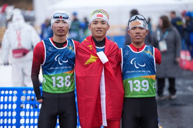 (260315) -- TESERO, March 15, 2026 -- Gold medalist Wang Chenyang (C), silver medalist Huang Lingxin (R), bronze medalist Liu Xiaobin of China pose after the para cross-country skiing men s 20km interval start free standing at the Milan-Cortina 2026 Paralympic Winter games, Winterspiele,Spiele, Summer games in Tesero, Italy, March 15, 2026. ) (SP)ITALY-TESERO-PARALYMPIC WINTER GAMES-PARA CROSS-COUNTRY SKIING-MEN S 20KM INTERVAL START FREE STANDING HouxZhaokang 