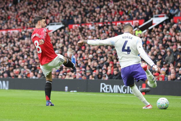 15th March 2026; Old Trafford, Manchester, England; Premier League Football, Manchester United, ManU versus Aston Villa; Ezri Konsa of Aston Villa clears under pressure from Bruno Fernandes of Manchester United  RogerxEvans Content restricted for UK based newspaper