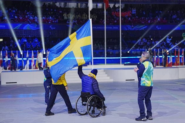 CORTINA, ITALY 20260315 Swedish flag bearers Marcus Holm and Ebba Arsjö enter during Sunday s closing ceremony for the Paralympics, in the Cortina curling stadium. *** The image is included in the SPORTS PACKAGE. For others PAYMENT IMAGE *** CORTINA ITALY x9200x *** CORTINA, ITALY 20260315 Swedish flag bearers Marcus Holm and Ebba Arsjö enter during Sunday s closing ceremony for the Paralympics, in the Cortina curling stadium The image is included in the SPORTS PACKAGE For others PAYMENT IMAGE CORTINA ITALY x9200x  Copyright: xBjörnxLarssonxRosvall TTx PARALYMPICS 2026 CONCLUSION