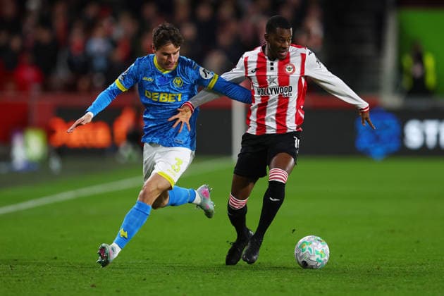 London, England, 16th March 2026. Hugo Bueno of Wolverhampton Wanderers and Dango Ouattara of Brentford challenge for the ball during the Brentford vs Wolverhampton Wanderers Premier League match at Gtech Community Stadium, London. Picture credit should read: Paul Terry Sportimage EDITORIAL USE ONLY. No use with unauthorised audio, video, data, fixture lists, club league logos or live services. Online in-match use limited to 120 images, no video emulation. No use in betting, games or single club league player publications. SPI_010_PT_Brentford_Wolves SPI-4606-0010
