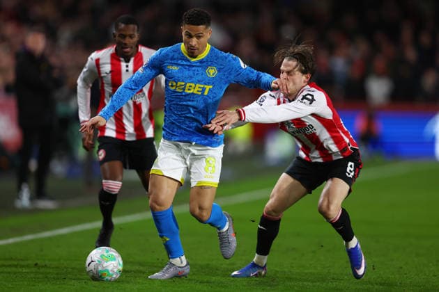 London, England, 16th March 2026. Joao Gomes of Wolverhampton Wanderers and Mathias Jensen of Brentford challenge for the ball during the Brentford vs Wolverhampton Wanderers Premier League match at Gtech Community Stadium, London. Picture credit should read: Paul Terry Sportimage EDITORIAL USE ONLY. No use with unauthorised audio, video, data, fixture lists, club league logos or live services. Online in-match use limited to 120 images, no video emulation. No use in betting, games or single club league player publications. SPI_011_PT_Brentford_Wolves SPI-4606-0011