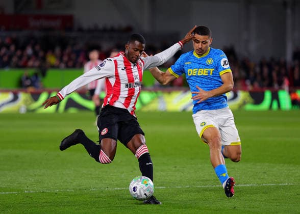 16th March 2026; Gtech Community Stadium, Brentford, London, England; Premier League Football, Brentford versus Wolverhampton Wanderers; Dango Ouattara of Brentford under pressure from Hugo Bueno of Wolverhampton Wanderers  JPxFletcher Content restricted for UK based newspaper