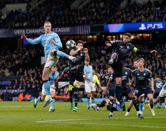 Manchester, England, 17th March 2026. Erling Haaland of Manchester City leaps up with Thiago Pitarch of Real Madrid during the Manchester City vs Real Madrid UEFA Champions League round of 16 match at the Etihad Stadium, Manchester. Picture credit should read: Andrew Yates Sportimage EDITORIAL USE ONLY. No use with unauthorised audio, video, data, fixture lists, club league logos or live services. Online in-match use limited to 120 images, no video emulation. No use in betting, games or single club league player publications. SPI_021_AY_ManCity_Madrid SPI-4612-0034