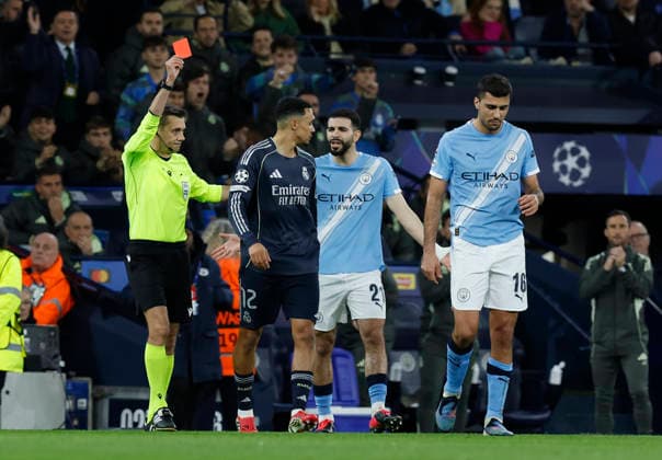 Manchester, England, 17th March 2026. Referee Clement Turpin issues are card to Bernardo Silva of Manchester City (not in picture) during the Manchester City vs Real Madrid UEFA Champions League round of 16 match at the Etihad Stadium, Manchester. Picture credit should read: Cody Froggatt Sportimage EDITORIAL USE ONLY. No use with unauthorised audio, video, data, fixture lists, club league logos or live services. Online in-match use limited to 120 images, no video emulation. No use in betting, games or single club league player publications. SPI_020_CF_ManCity_Madrid SPI-4612-0045