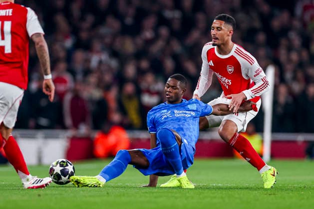 LONDON, ENGLAND - MARCH 17: Christian Kofane of Bayer 04 Leverkusen and William Saliba of Arsenal battle for the ball during the UEFA Champions League 2025 26 Round of 16 Second Leg match between Arsenal FC and Bayer 04 Leverkusen at Arsenal Stadium on March 17, 2026 in London, England.  Copyright: xRenexNijhuis MBxMediax