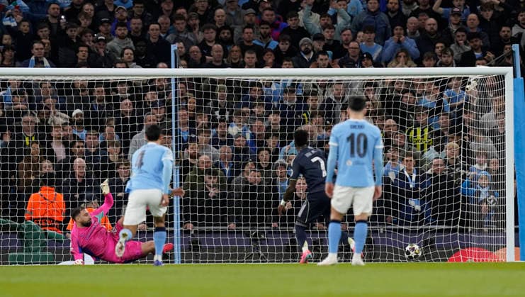 Manchester, England, 17th March 2026. Gianluigi Donnarumma of Manchester City is sent the wrong way by Vinicius Junior of Real Madrid for the first goal from the penalty spot during the Manchester City vs Real Madrid UEFA Champions League round of 16 match at the Etihad Stadium, Manchester. Picture credit should read: Andrew Yates Sportimage EDITORIAL USE ONLY. No use with unauthorised audio, video, data, fixture lists, club league logos or live services. Online in-match use limited to 120 images, no video emulation. No use in betting, games or single club league player publications. SPI_030_AY_ManCity_Madrid SPI-4612-0062