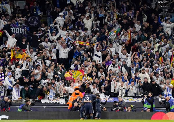 Manchester, England, 17th March 2026. Real Madrid fans celebrate the first goal with their players during the Manchester City vs Real Madrid UEFA Champions League round of 16 match at the Etihad Stadium, Manchester. Picture credit should read: Andrew Yates Sportimage EDITORIAL USE ONLY. No use with unauthorised audio, video, data, fixture lists, club league logos or live services. Online in-match use limited to 120 images, no video emulation. No use in betting, games or single club league player publications. SPI_031_AY_ManCity_Madrid SPI-4612-0063