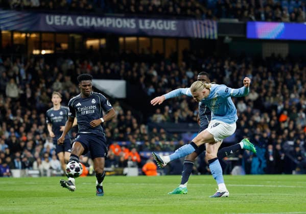 Manchester, England, 17th March 2026. Erling Haaland of Manchester City shoots as Aurelien Tchouameni of Real Madrid closes in during the Manchester City vs Real Madrid UEFA Champions League round of 16 match at the Etihad Stadium, Manchester. Picture credit should read: Cody Froggatt Sportimage EDITORIAL USE ONLY. No use with unauthorised audio, video, data, fixture lists, club league logos or live services. Online in-match use limited to 120 images, no video emulation. No use in betting, games or single club league player publications. SPI_045_CF_ManCity_Madrid SPI-4612-0090