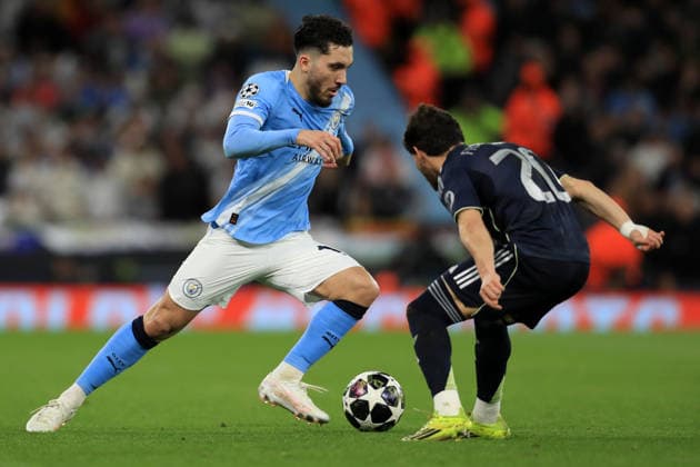 17th March 2026; Etihad Stadium, Manchester, England; UEFA Champions League Football, Manchester City versus Real Madrid; Rayan Cherki of Manchester City takes on Fran Garcia of Real Madrid  DavidxBlunsden Content restricted for UK based newspaper