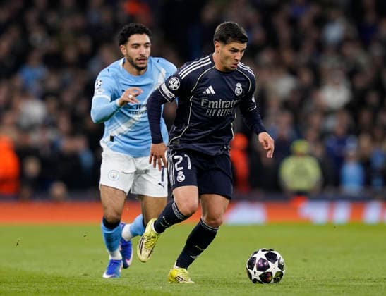Manchester, England, 17th March 2026. Brahim Diaz of Real Madrid and Omar Marmoush of Manchester City during the Manchester City vs Real Madrid UEFA Champions League round of 16 match at the Etihad Stadium, Manchester. Picture credit should read: Andrew Yates Sportimage EDITORIAL USE ONLY. No use with unauthorised audio, video, data, fixture lists, club league logos or live services. Online in-match use limited to 120 images, no video emulation. No use in betting, games or single club league player publications. SPI_051_AY_ManCity_Madrid SPI-4612-0096