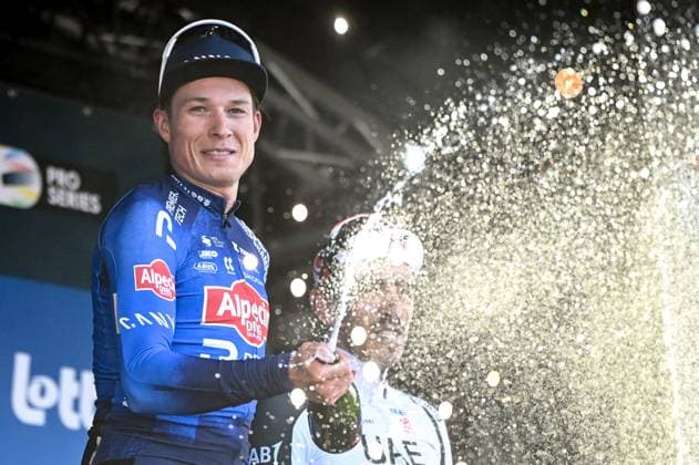 Belgian Jasper Philipsen of Alpecin-Premier Tech celebrates on the podium with champagne after winning the Nokere Koerse one day cycling race for men elite, 186,4 km from Deinze to Nokere, Kruisem on Wednesday 18 March 2026. ELIASxROM  x168034094x