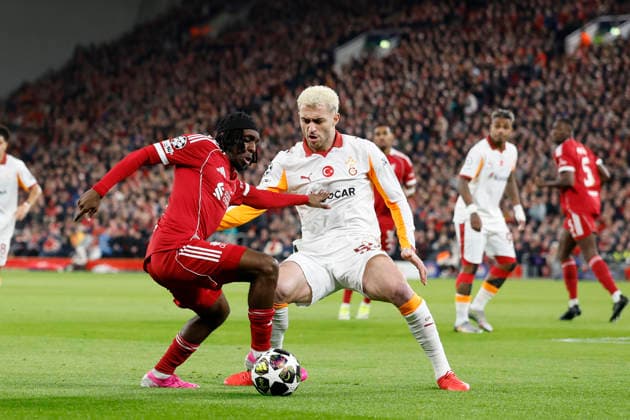 Liverpool, England, 18th March 2026. Jeremie Frimpong of Liverpool and Baris Alper Yilmaz of Galatasaray challenge for the ball during the Liverpool vs Galatasaray UEFA Champions League round of 16 match at Anfield, Liverpool. Picture credit should read: Cody Froggatt Sportimage EDITORIAL USE ONLY. No use with unauthorised audio, video, data, fixture lists, club league logos or live services. Online in-match use limited to 120 images, no video emulation. No use in betting, games or single club league player publications. SPI_021_CF_Liverpool_Galatasaray SPI-4618-0021