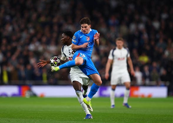 18th March 2026; Tottenham Hotspur Stadium, London, England; UEFA Champions League Football, Tottenham Hotspur versus Atletico Madrid; Julian Alvarez of Atletico Madrid under pressure from Pape Matar Sarr of Tottenham Hotspur  JPxFletcher Content restricted for UK based newspaper