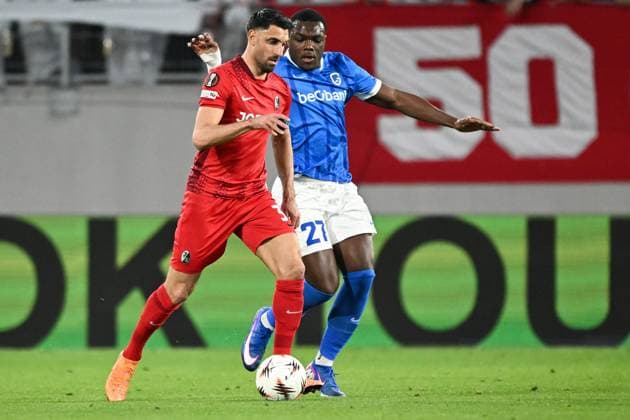 Freiburg s Vincenzo Grifo and Genk s Ken Nkuba pictured in action during a soccer game between German Club Freiburg and Belgian KRC Genk in Freiburg im Breisgau, Germany on Thursday 19 March 2026, the return leg of the 1 16 Finals of the UEFA Europa League tournament. Genk won the first leg 1-0. JILLxDELSAUX  x168211768x