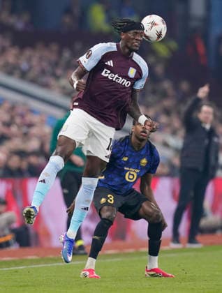 Birmingham, England, 19th March 2026. Tammy Abrahams of Aston Villa leaps for the ball in front of Nathan Ngoy of LOSC Lille during the Aston Villa vs LOSC Lille UEFA Europa League round of 16 match at Villa Park, Birmingham. Picture credit should read: Andrew Yates Sportimage EDITORIAL USE ONLY. No use with unauthorised audio, video, data, fixture lists, club league logos or live services. Online in-match use limited to 120 images, no video emulation. No use in betting, games or single club league player publications. SPI_026_AY_Villa_Lille SPI-4627-0026