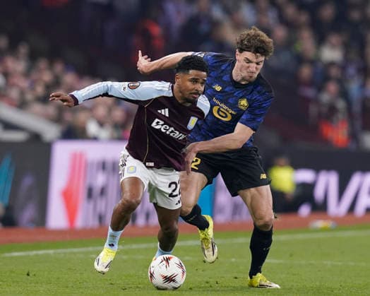 Birmingham, England, 19th March 2026. Ian Maatsen of Aston Villa tussles with Thomas Meunier of LOSC Lille during the Aston Villa vs LOSC Lille UEFA Europa League round of 16 match at Villa Park, Birmingham. Picture credit should read: Andrew Yates Sportimage EDITORIAL USE ONLY. No use with unauthorised audio, video, data, fixture lists, club league logos or live services. Online in-match use limited to 120 images, no video emulation. No use in betting, games or single club league player publications. SPI_031_AY_Villa_Lille SPI-4627-0031