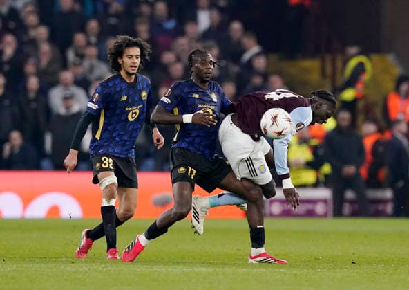 Birmingham, England, 19th March 2026. Ngal™ayel Mukau of LOSC Lille tackles Amadou Onana of Aston Villa during the Aston Villa vs LOSC Lille UEFA Europa League round of 16 match at Villa Park, Birmingham. Picture credit should read: Andrew Yates Sportimage EDITORIAL USE ONLY. No use with unauthorised audio, video, data, fixture lists, club league logos or live services. Online in-match use limited to 120 images, no video emulation. No use in betting, games or single club league player publications. SPI_038_AY_Villa_Lille SPI-4627-0038