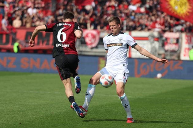 21 03 2026, xrekx, Fußball 2 Bundesliga, 1 FC Nuernberg 1 FC Kaiserslautern v l Adam Markhiev 1 FC Nuernberg Fabian Kunze 1 FC Kaiserslautern Zweikampf, Aktion, action, battle for the ball DFL DFB REGULATIONS PROHIBIT ANY USE OF PHOTOGRAPHS as IMAGE SEQUENCES and or QUASI VIDEO Nuernberg