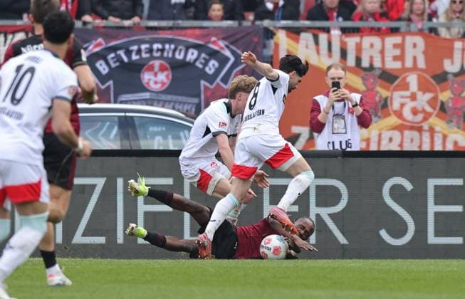 21 03 2026 Soccer Season 2025 2026 2 Soccer Bundesliga 27 Matchday 1 FC Nürnberg FCN Club 1 FC Kaiserslautern FCK Rote Roten Teufel Sportfoto Zink DaMa xdaxmax DFL regulations prohibit any use of photographs as image sequences and or quasi video only for editorial use Mika Haas 22, 1 FC Kaiserslautern FCK Semih Sahin 8, 1 FC Kaiserslautern FCK bring down Mohamed Ali Zoma 23, 1 FC Nürnberg FCN in penalty area for penalty foul