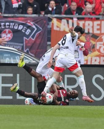 21 03 2026 Soccer Season 2025 2026 2 Soccer Bundesliga 27 Matchday 1 FC Nürnberg FCN Club 1 FC Kaiserslautern FCK Rote Roten Teufel Sportfoto Zink DaMa xdaxmax DFL regulations prohibit any use of photographs as image sequences and or quasi video only for editorial use Mika Haas 22, 1 FC Kaiserslautern FCK Semih Sahin 8, 1 FC Kaiserslautern FCK bring down Mohamed Ali Zoma 23, 1 FC Nürnberg FCN in penalty area for penalty foul