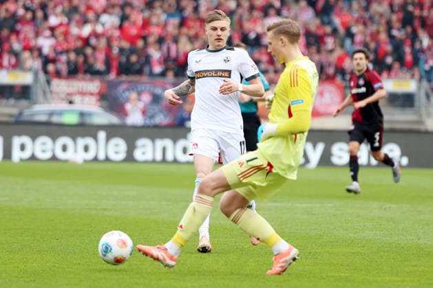 21 03 2026, xrekx, Fußball 2 Bundesliga, 1 FC Nuernberg 1 FC Kaiserslautern v l Norman Bassette 1 FC Kaiserslautern Jan Reichert 1 FC Nuernberg DFL DFB REGULATIONS PROHIBIT ANY USE OF PHOTOGRAPHS as IMAGE SEQUENCES and or QUASI VIDEO Nuernberg