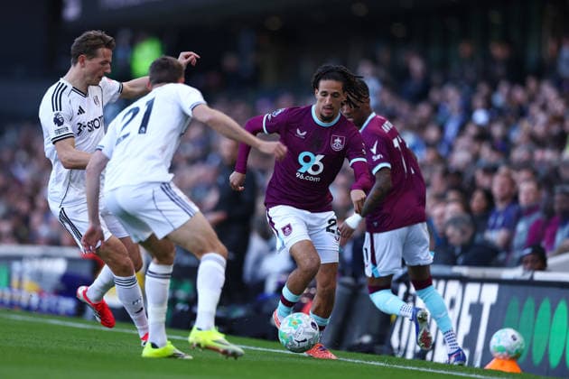 21st March 2026; Craven Cottage, Fulham, London, England; Premier League Football, Fulham versus Burnley; Hannibal Mejbri of Burnley under pressure from Timothy Castagne of Fulham  JPxFletcher Content restricted for UK based newspaper