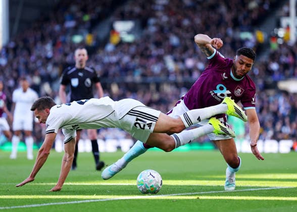 21st March 2026; Craven Cottage, Fulham, London, England; Premier League Football, Fulham versus Burnley; Timothy Castagne of Fulham tackled by Josh Laurent of Burnley  JPxFletcher Content restricted for UK based newspaper