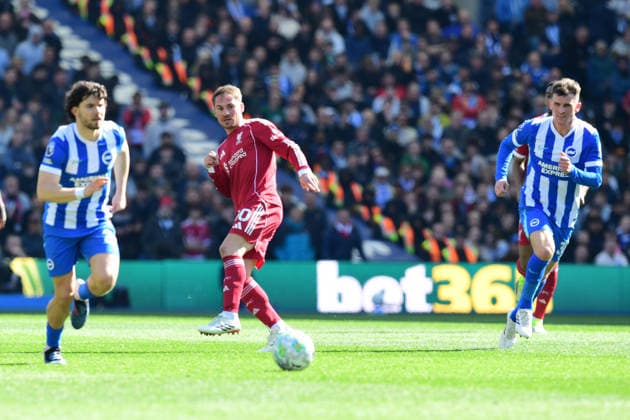 Brighton and Hove Albion v Liverpool, Premier League Alexis Mac Allister Midfielder of Liverpool plays a through ball between Ferdi KadÄ±oÄülu Defender of Brighton and Hove Albion and Pascal Gross Midfielder of Brighton and Hove Albion during the Premier League match between Brighton and Hove Albion and Liverpool at the American Express Stadium, Brighton and Hove, UK on 21 March 2026. Brighton and Hove American Express Stadium East Sussex UK Editorial use only DataCo restrictions apply See www.football-dataco.com , Copyright: xJeffxMoodx PSI-23949-0069