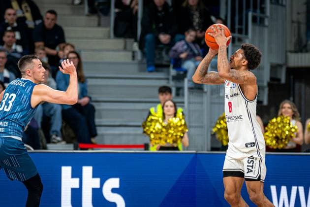 Game action with Ryan Mikesell 33 MLP Academics Heidelberg in blue jersey and Demarcus Demonia 8 BMA365 Bamberg Baskets in white jersey throwing easyCredit BBL MLP Academics Heidelberg - Bamberg Baskets Copyright: xSpeedshotx